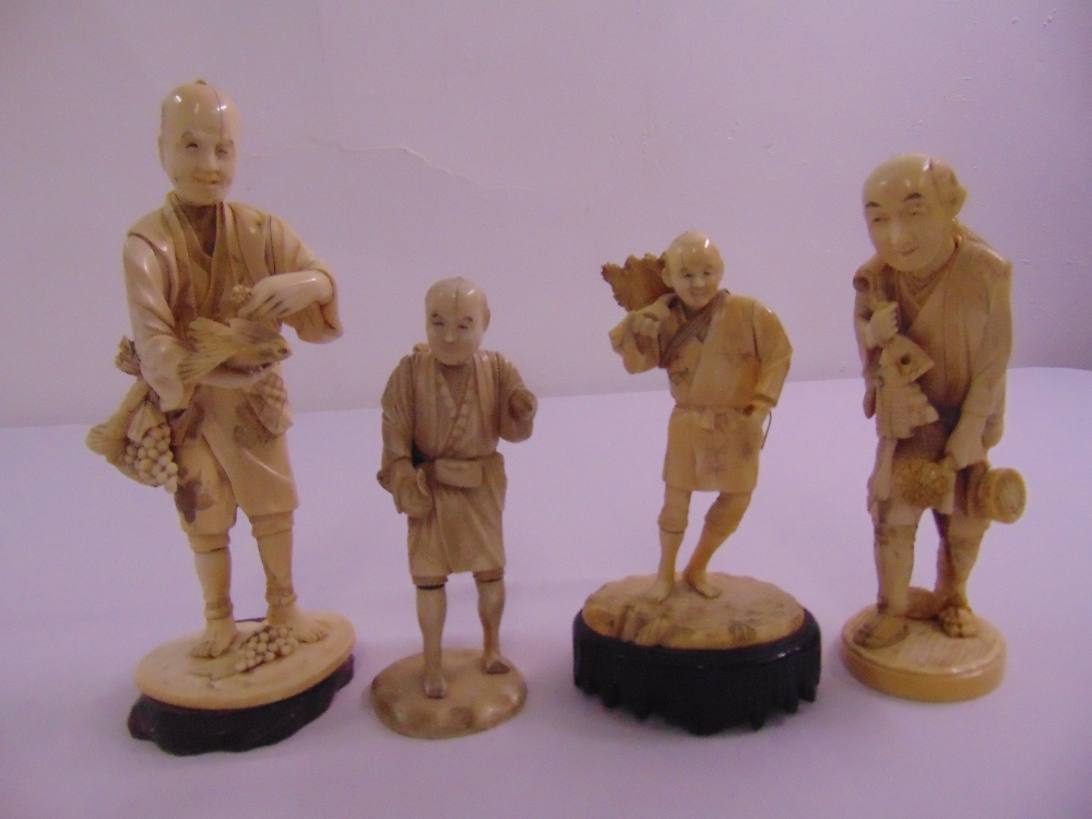 Four 19th century ivory oriental figurines on raised bases all signed