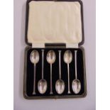 A cased set of silver coffee spoons with slip top terminals