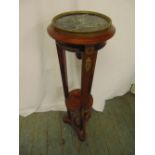 A continental mahogany torchere, the circular top on three tapering rectangular supports with