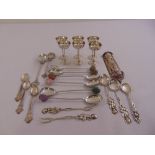 A quantity of decorative white metal spoons, a set of six white metal liquor tots