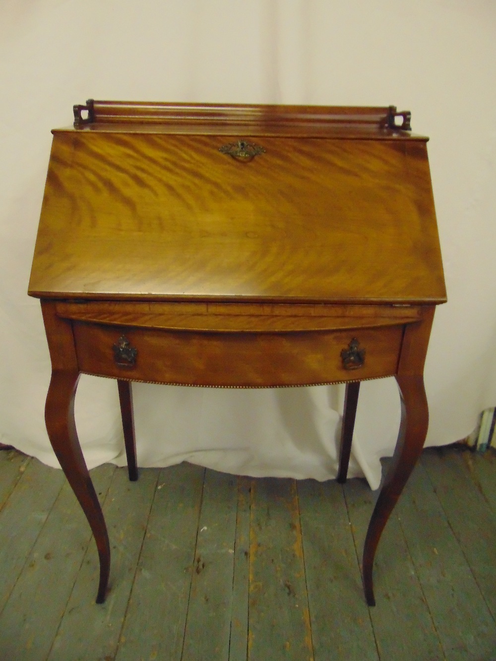 A 19th century rectangular mahogany drop flap bureau with single drop on four cabriole legs
