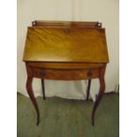 A 19th century rectangular mahogany drop flap bureau with single drop on four cabriole legs