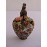 A Chinese enamel snuff bottle decorated with birds, flowers and leaves