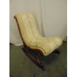 A Victorian mahogany upholstered rocking chair