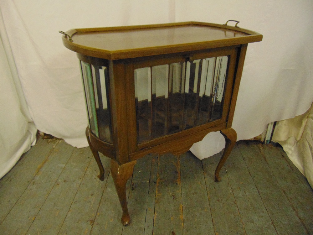 A rectangular mahogany and glass cabinet on four cabriole legs with detachable tea tray