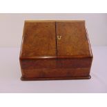 A walnut rectangular table top stationery box with hinged doors, to include key