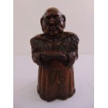 A continental carved wooden candle box in the form of a gentleman wearing a coat