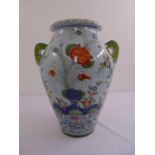 An Italian Majolica ovoid vase with two side handles decorated with flowers and leaves, A/F
