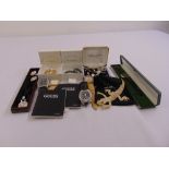 A quantity of costume jewellery to include cased brooches, wristwatches and cufflinks