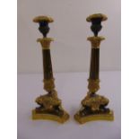A pair of 19th century ormolu table candlesticks, fluted tapering stems on triform bases with vase