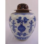 A Chinese blue and white ginger jar decorated with scrolls, flowers and leaves with pierced wooden