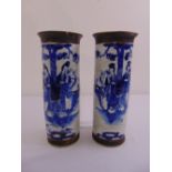 A pair of Chinese crackle glazed blue and white cylindrical vases decorated with figures in a
