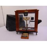 An Oertling balance scale in fitted glazed mahogany case, to include cased weights