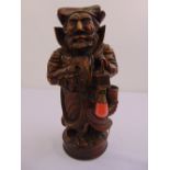 A continental carved candle box in the form of a male figurine