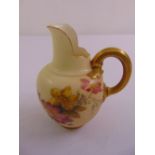 A Royal Worcester blush ivory hand painted jug with gilded handle numbered 29115/1094