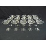 A set of fifteen clear glass champagne glasses