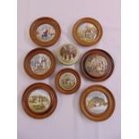 Seven porcelain pot lids mounted in wooden frames and another (8)