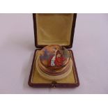 A Victorian enamel and gilded metal powder jar, the hinged cover decorated with a seated lady