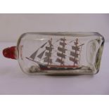 A model of a sailing ship in a bottle, circa 1944, sails made from a WWII barrage balloon