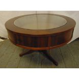 A mahogany circular coffee table with glass display case to the centre on three outswept legs