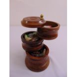 A mahogany three tier circular sewing stand with accessories