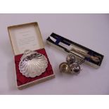 A quantity of silver to include a cased shell dish, a cased grapefruit knife and condiments