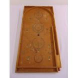 An early 20th century bagatelle board of customary form