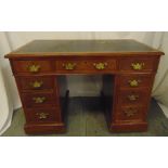 An Edwardian rectangular mahogany kneehole desk with inset tooled leather top and brass swing