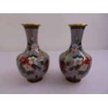 A pair of mid 20th century cloisonn‚ vases decorated with flowers and leaves