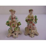 A pair of late 19th century English porcelain figurines of a boy and a girl with flowers