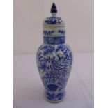 A Chinese blue and white baluster vase decorated with leaves and foliage and raised pull off cover