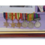A framed and glazed WWII montage of medals to include a Palestine medal, attributed to Walter