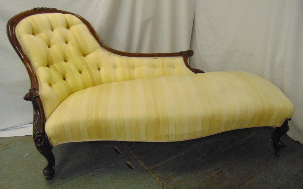 A Victorian upholstered chaise longue with button back on mahogany scroll feet