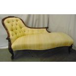 A Victorian upholstered chaise longue with button back on mahogany scroll feet