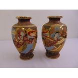 A pair of ovoid Satsuma vases decorated with figures to the sides