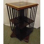 An Edwardian rectangular revolving bookcase, the top with satinwood cross banded border and inlaid