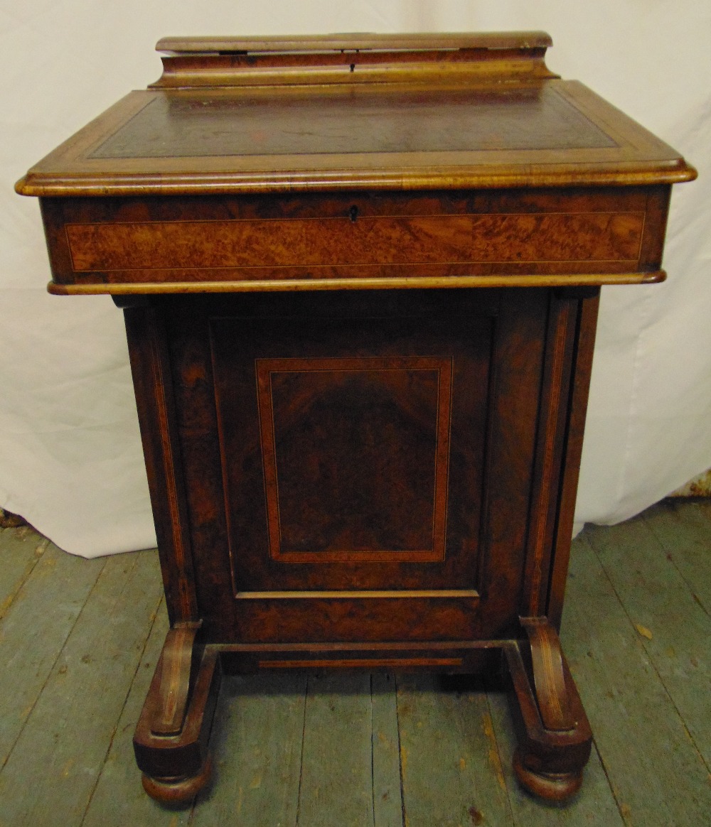 A Victorian rectangular walnut Davenport of customary form