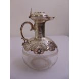 A Victorian silver mounted claret jug, the oval etched glass body with scroll pierced silver mounts,