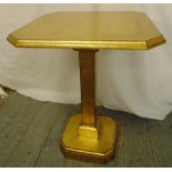 A gilded wooden rectangular side table on pedestal base