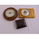 Two wall mounted barometers and a Bakelite hinged case