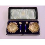 A cased set of shell shaped salts to include a condiment spoon, Birmingham 1902, A/F