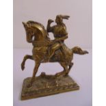 A cast brass figurine of man on horseback mounted on a rectangular plinth