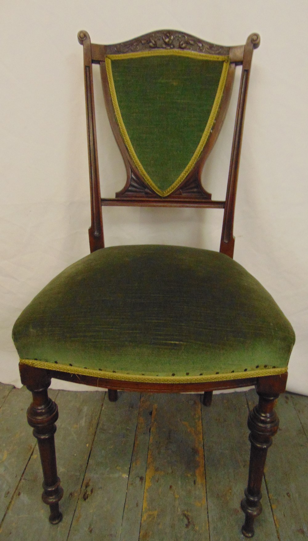 An Edwardian mahogany occasional chair with upholstered seat and back