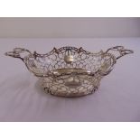 A Victorian silver two handled fruit bowl, the sides pierced with four cartouche panels, on raised