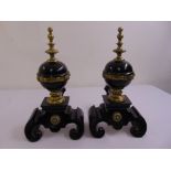 A pair of Victorian brass and black metal fire dogs