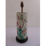 A famille verte cylindrical table lamp decorated with flowers and birds on hardwood stand
