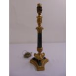A French gilt metal and bronze table lamp of columnular form on triform base