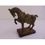 An early 20th century Tang bronze horse on a wooden rectangular base