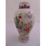 A Chinese famille rose baluster vase decorated with figures in a procession