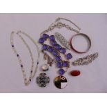 A quantity of costume jewellery to include necklaces, bracelets, brooches, a ring and a bangle